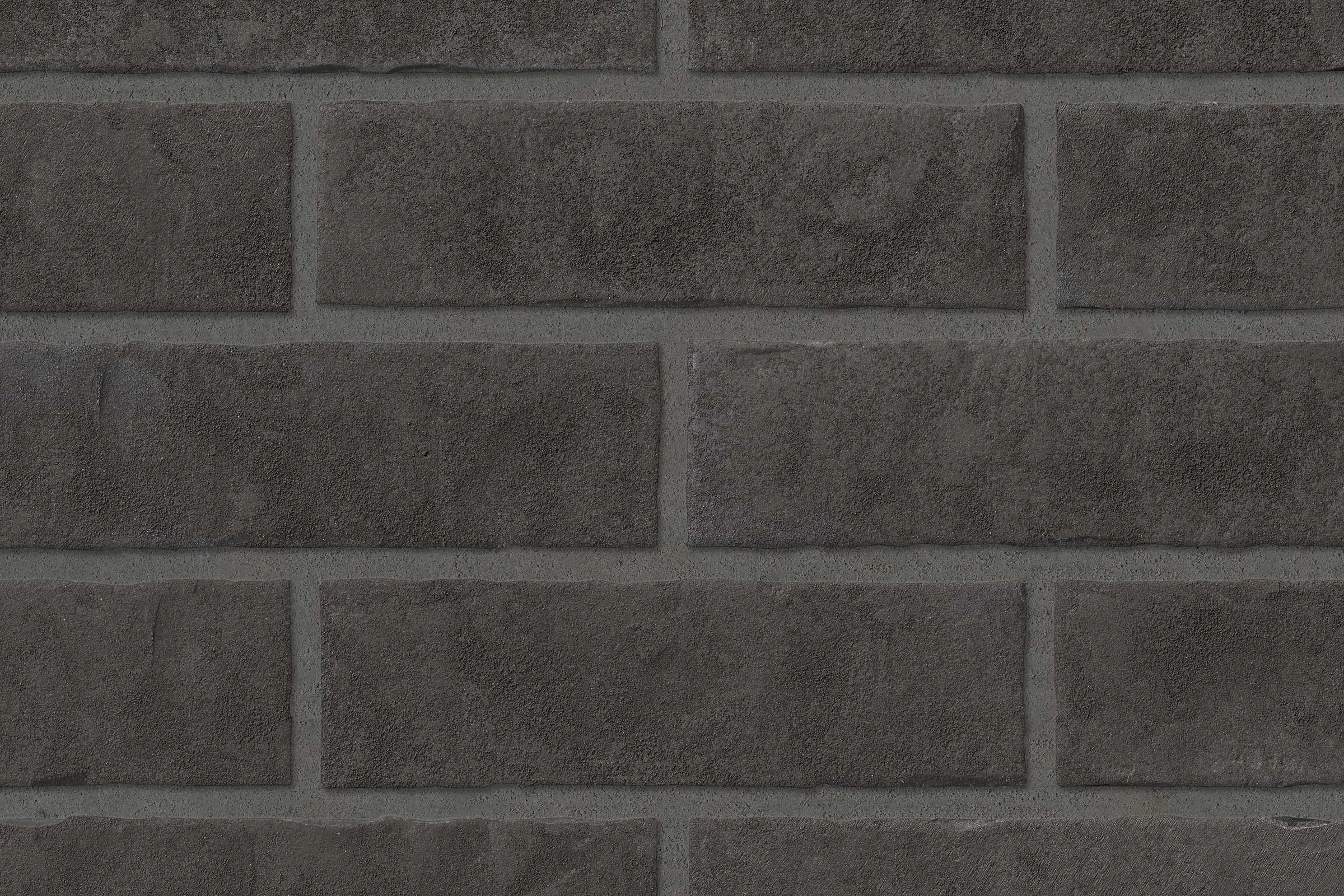Superficie dei mattone faccia vista grigio scuro con finitura sabbiata